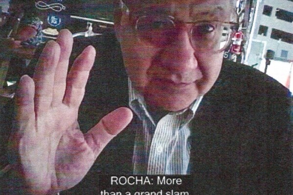 This image provided by the Justice Department and contained in the affidavit in support of a criminal complaint, shows Manuel Rocha during a meeting with a FBI undercover employee. The Justice Department says Rocha, a former American diplomat who served as U.S. ambassador to Bolivia, has been charged with serving as a covert agent for Cuba's intelligence services since at least 1981. Newly unsealed court papers allege that Manuel Rocha engaged in "clandestine activity" on Cuba's behalf for decades, including by meeting with Cuban intelligence operatives. (Justice Department via AP)