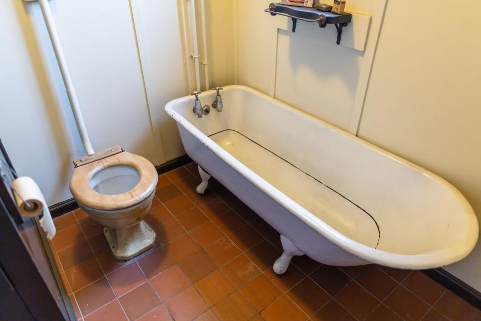 Mid twentieth century British bathroom with bath and toilet