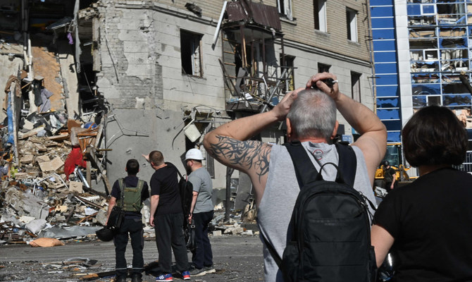 Local residents react near a residential building destroyed by an aerial bomb explosion in the centre of Kharkiv. (AFP) Trillion-dollar reconstruction of Ukraine is back on Europe’s agenda