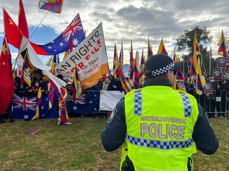 REUTERS/PETER HOBSON / JUNE 17
                                Protestors and supporters gather as Chinas Premier Li Qiang arrives ahead of a meeting with Australias Prime Minister Anthony Albanese, outside the Australian Parliament House in Canberra, Australia.