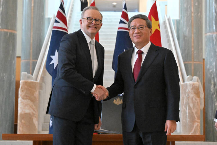 MICK TSIKAS/POOL VIA REUTERS / JUNE 17
                                Chinese Premier Li Qiang shakes hands with Australias Prime Minister Anthony Albanese at the Australian Parliament House in Canberra, Australia.