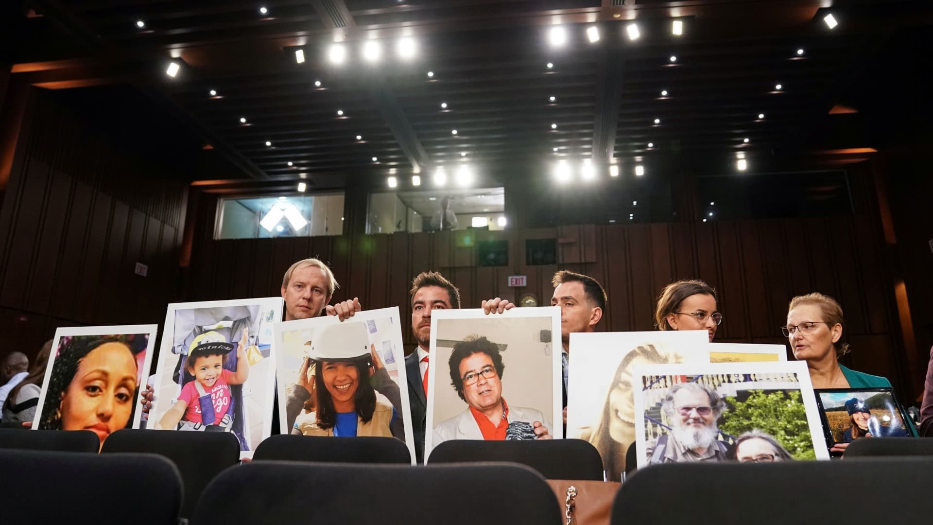 Family members hold photographs of Boeing 737 MAX crash victims lost in two deadly 737 MAX crashes that killed 346 people as Boeing CEO Dennis Muilenburg testifies before a Senate Commerce, Science and Transportation Committee hearing on “aviation safety” and the grounded 737 MAX on Capitol Hill in Washington, October 29, 2019.