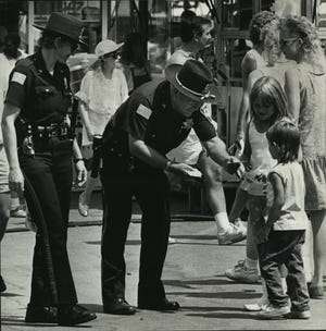 Beverly and Bryant Van Cronkite officers at State Fair Park, handed out baseball cards to children in 1986.