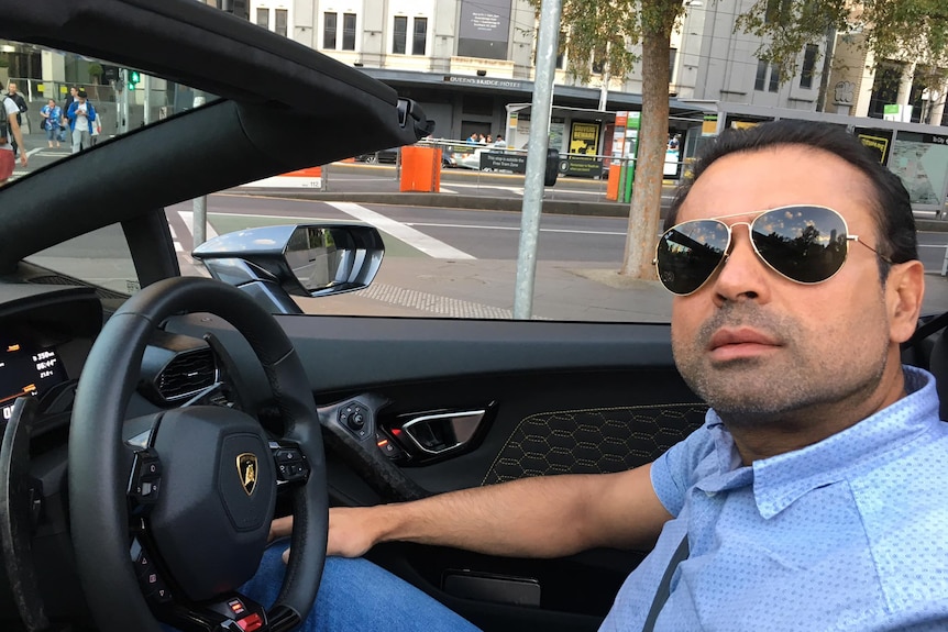 Amit Miglani takes a selfie of himself as he drives a luxury car