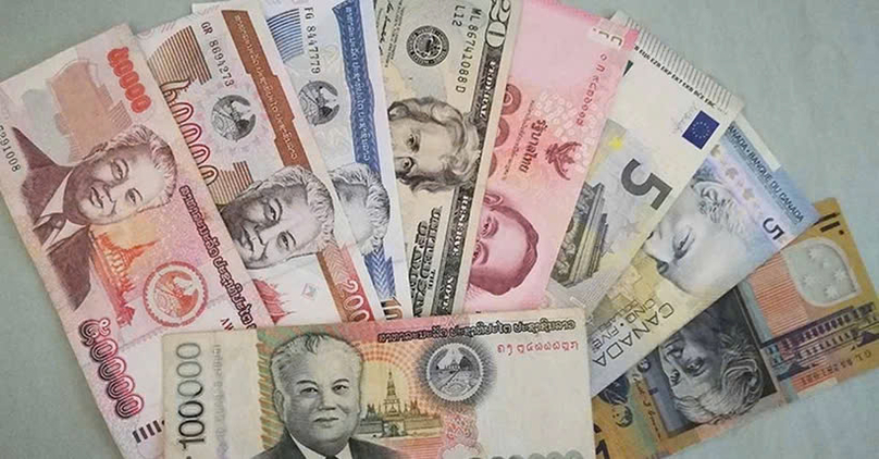 Foreign and Lao currencies. Photo courtesy of https://laotiantimes.com.