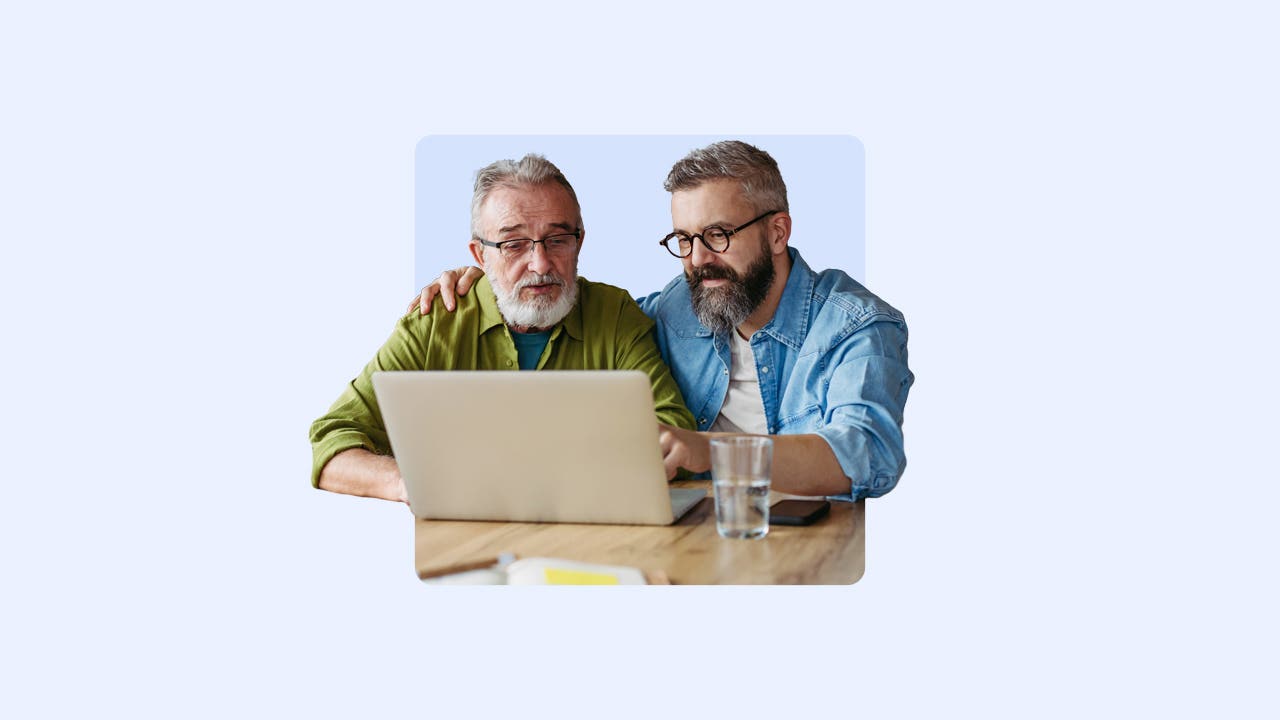 Two people looking at a laptop.