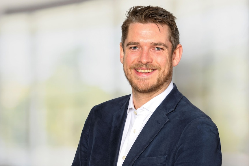 A head shot of a man in a suit.