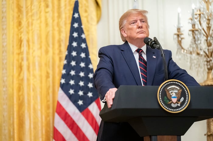 Donald Trump speaking with reporters from the East Room of the White House.