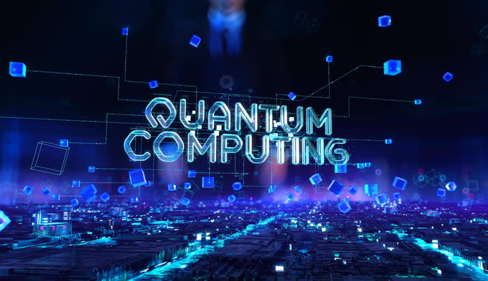 The words quantum computing are shown against a blue digital background.