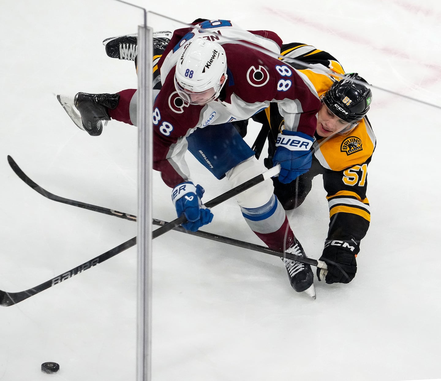 Bruins forward Matthew Poitras (right) battles Colorado's Martin Necas, who was making his Avalanche debut after Friday night's stunning blockbuster.