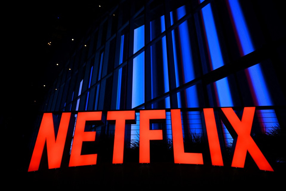 a large red netflix sign is lit up in front of a building