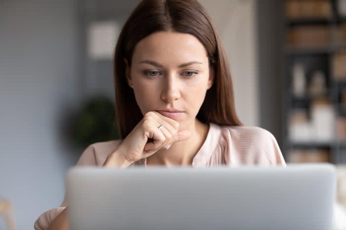 A person looks at a laptop screen.