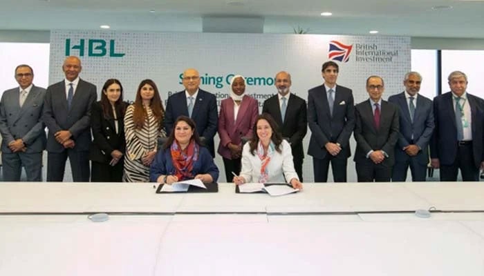 Maya Inayat Ismail — Chair, HBL Microfinance Bank and HBL Sustainability Committee (left) and Maria Smith – Chief Impact Officer, BII (right) sign agreement. — HBL/BII