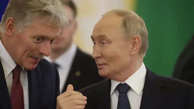 Dmitry Peskov (L) and Vladimir Putin (R)