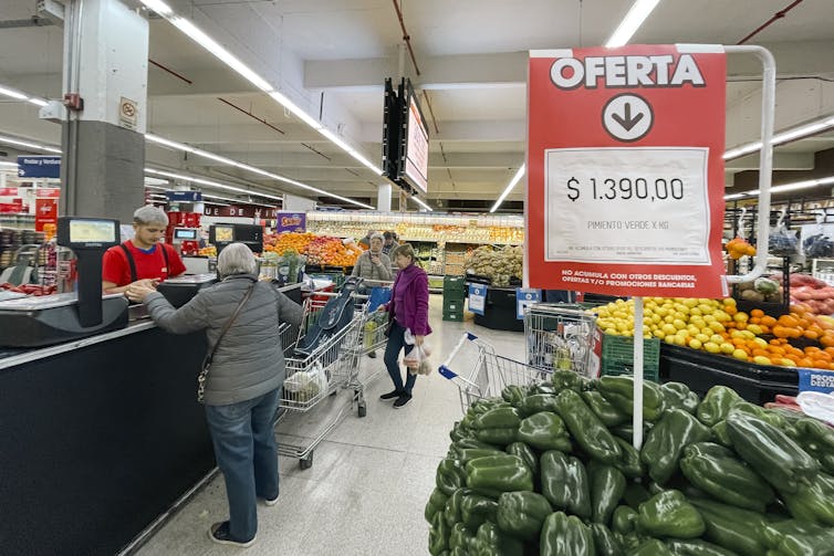 supermarket in argentina showing green peppers on sale for 1,390 pesos per kilogram