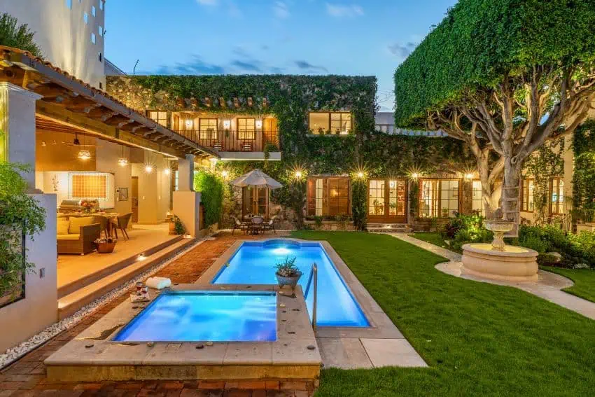 View of a luxury home with a pool.