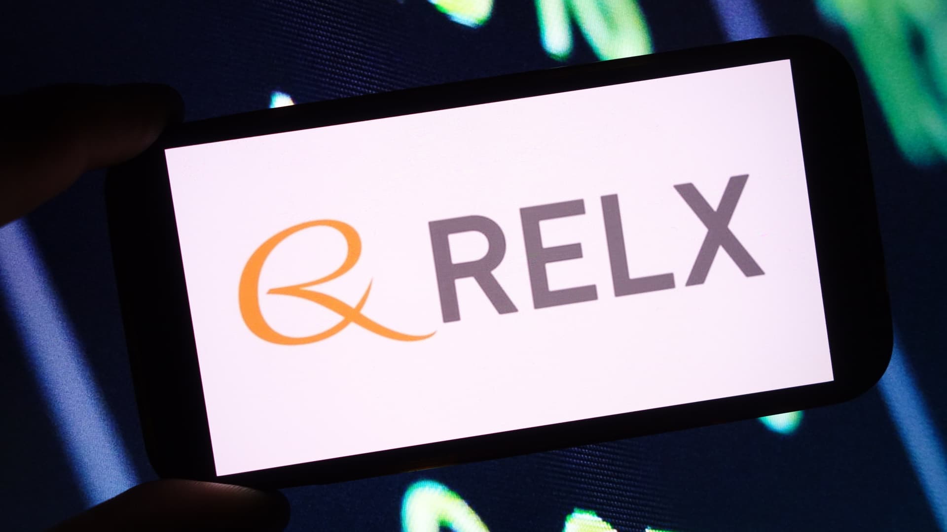 In this photo illustration, the RELX company logo is seen displayed on a smartphone screen.
