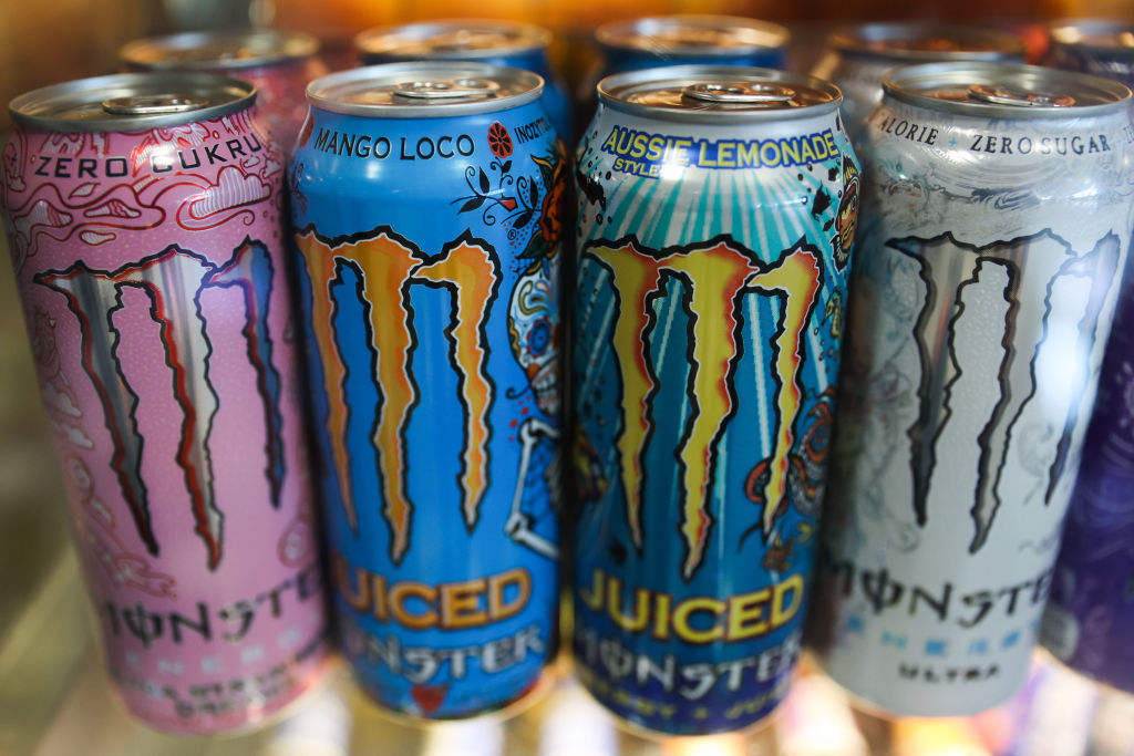 Close-up of Monster Beverage energy drinks in pink, blue and silver cans