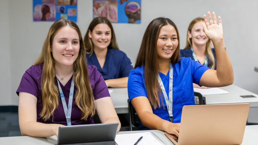 Nursing students in a classroom with laptops