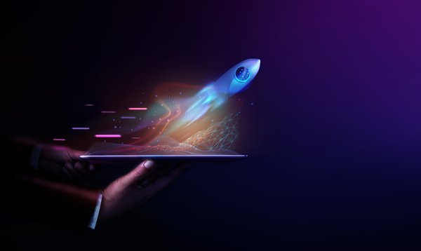 Someone holding a tablet with a rocket flying out of it.