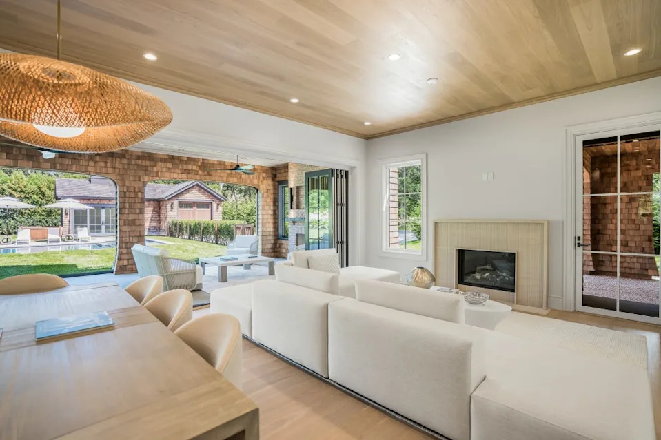 The great room comes with a fireplace and opens to the outdoors. Real Shot Studios