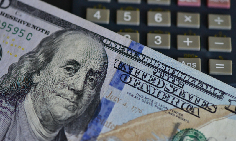 An illustration show a US dollar bill and a calculator at a bank in Fuyang, East China's Anhui Province. Photo: VCG