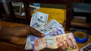 A photo of cedi and dollar notes