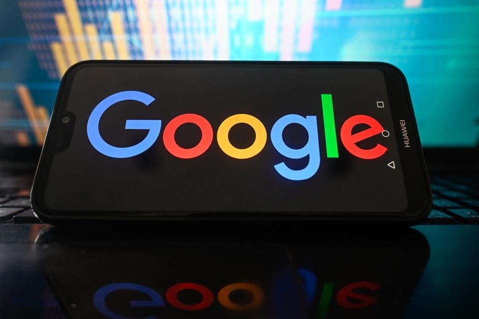In this photo a Google logo is seen displayed on a...