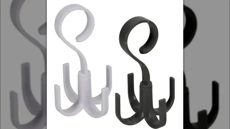 Two plastic rotating hook sets, one white and one black, with loop attachments at their tops and four hooks hanging carousel-style beneath each