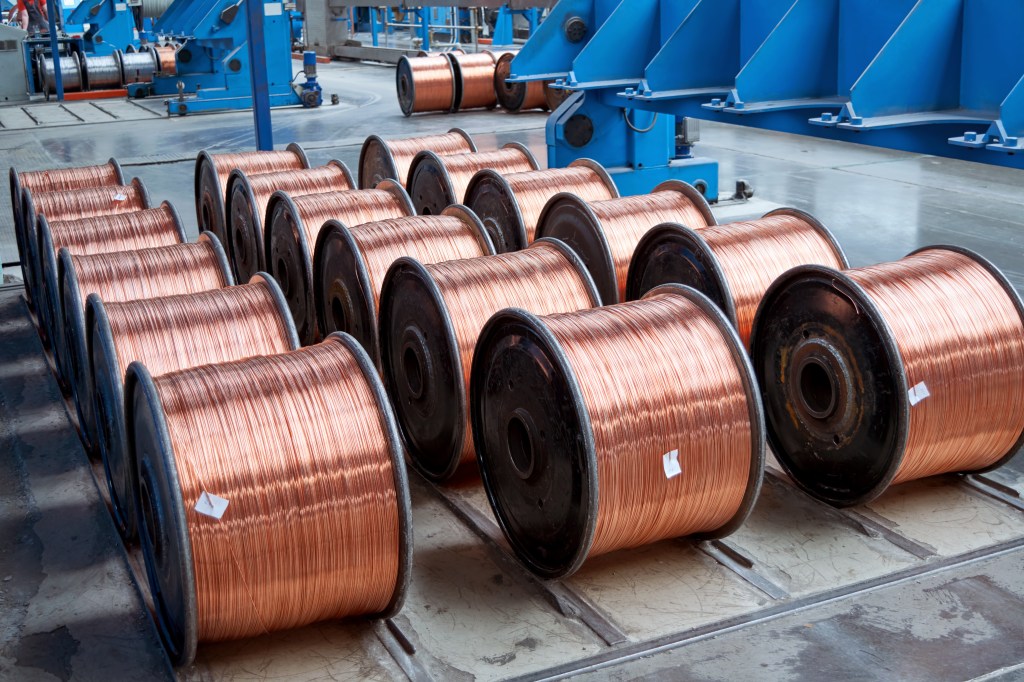 Rows of spools of copper wire in a factory.