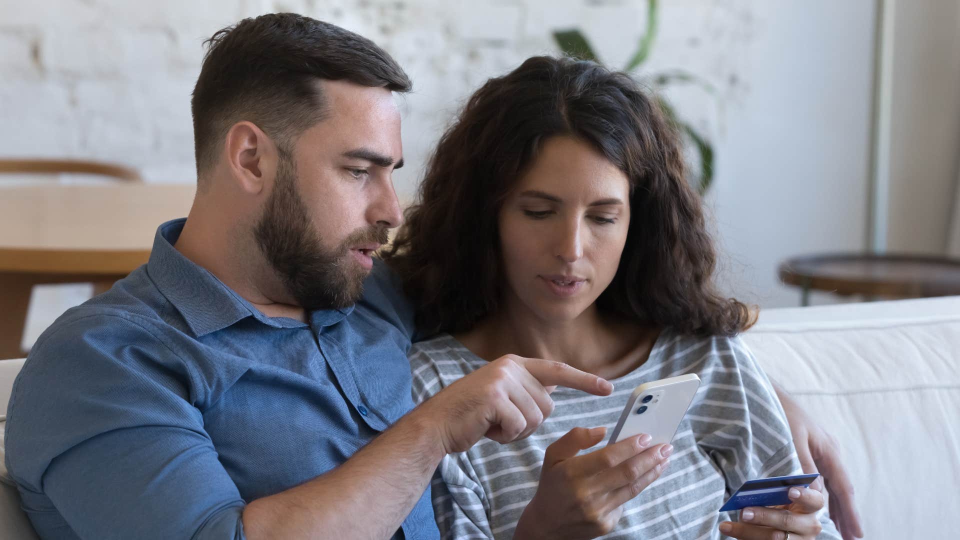 couple looking at product on phone to price match