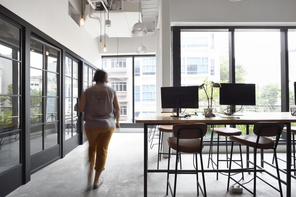 Woman walking through a co-working office