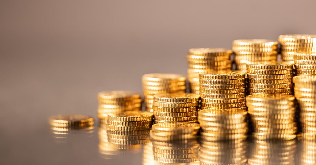 Pile of stacked shiny golden Euro coins close-up 