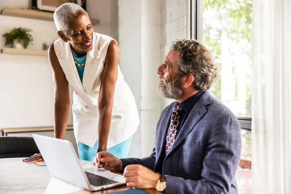 Business colleagues smiling and working together in modern conference room