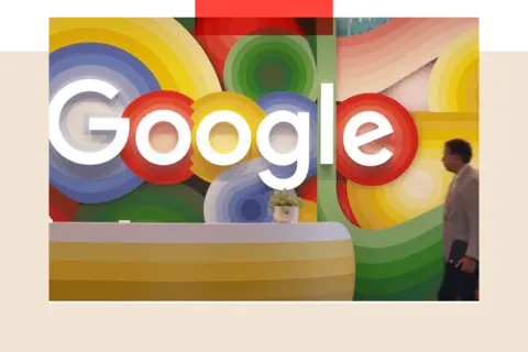 A blurred person passing a colourful Google sign