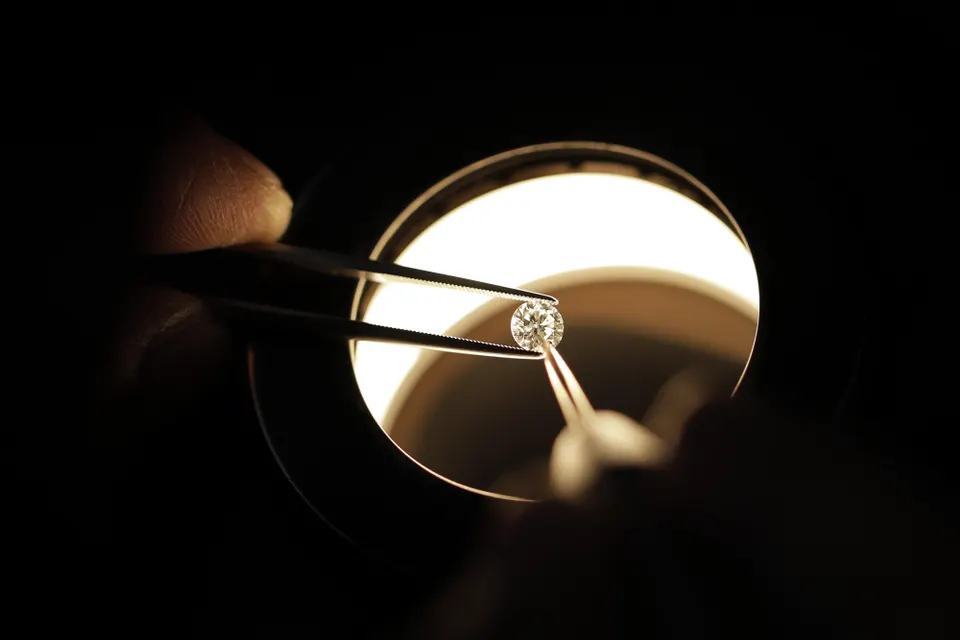 A employee inspects a diamond