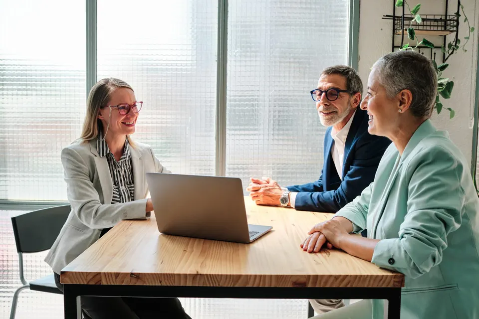 A financial advisor meeting with clients