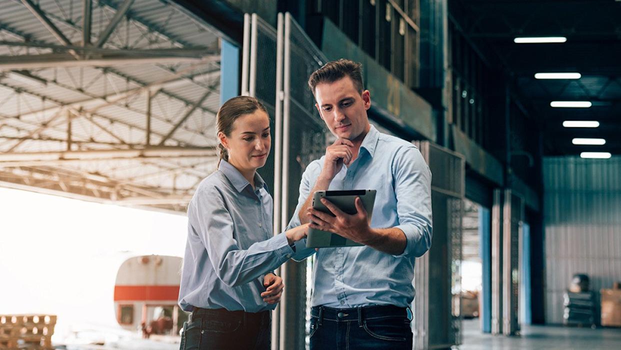 Warehouse managers checking logistic systems at work. - kelvn // Shutterstock