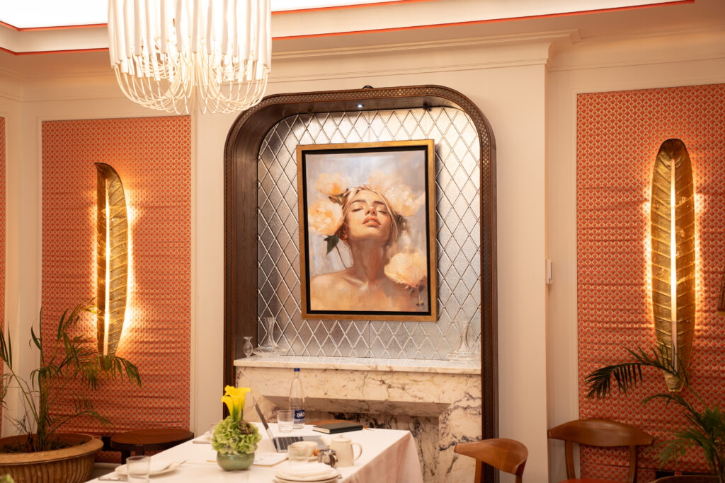 Gabrielle Malak portrait displayed above a marble fireplace at La Maison Ani