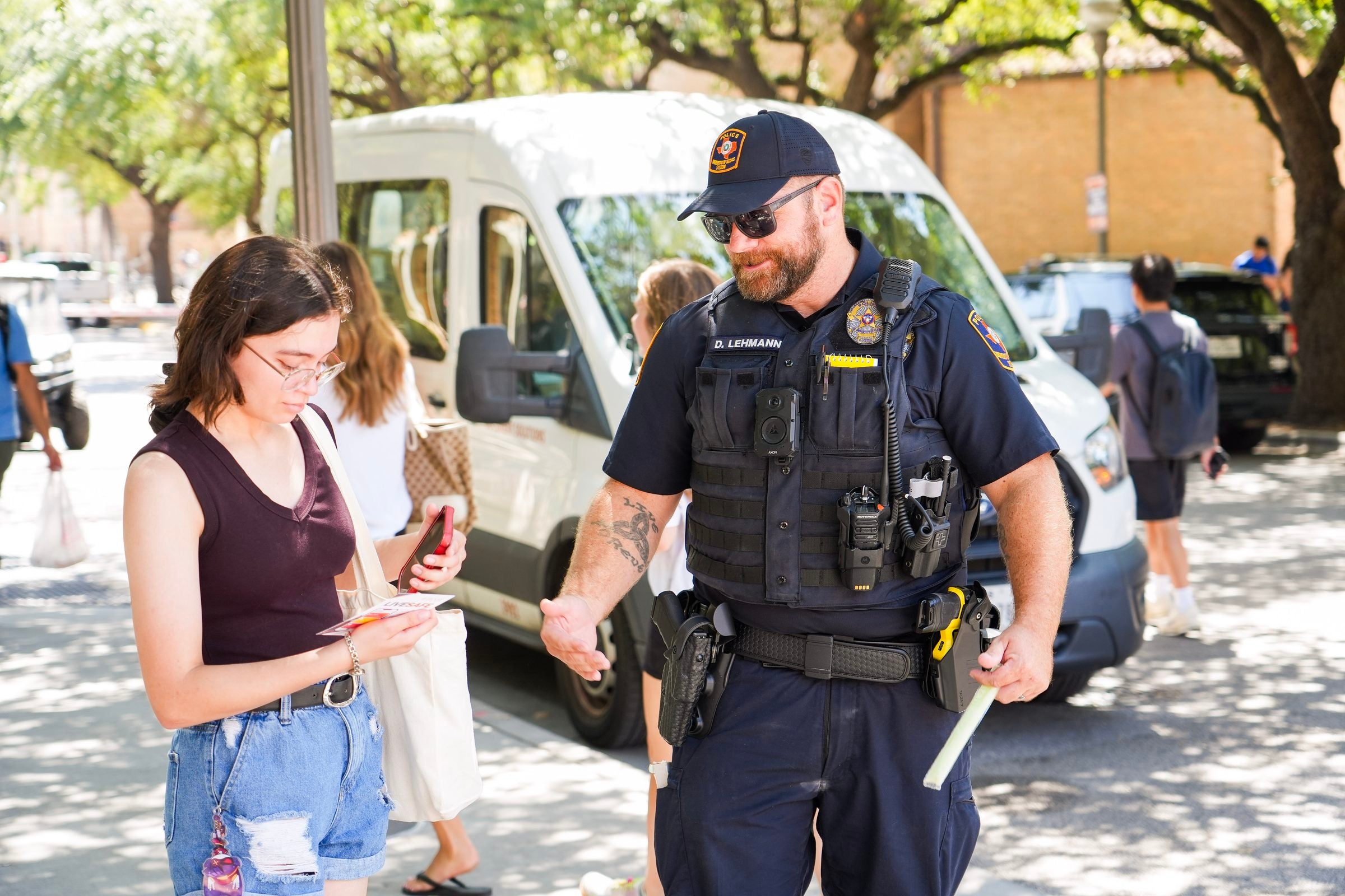 image of a police officer handing someone a flyer