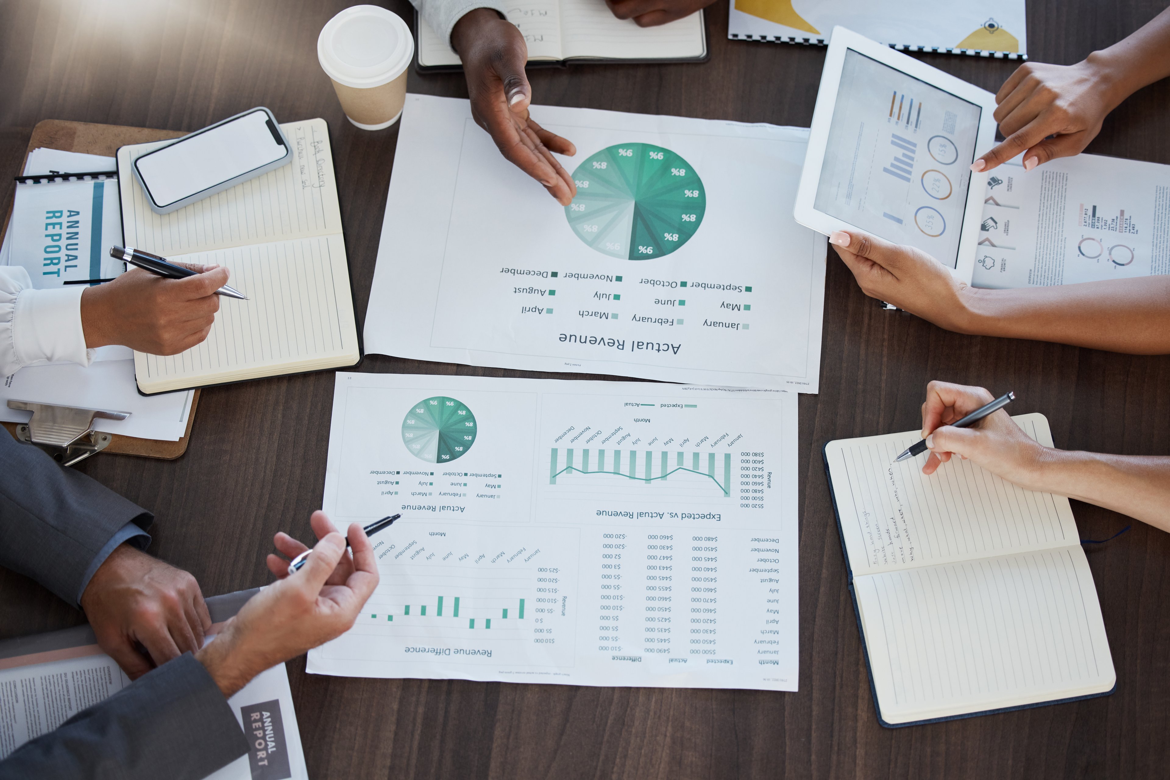 People pore over spreadsheets and data. 