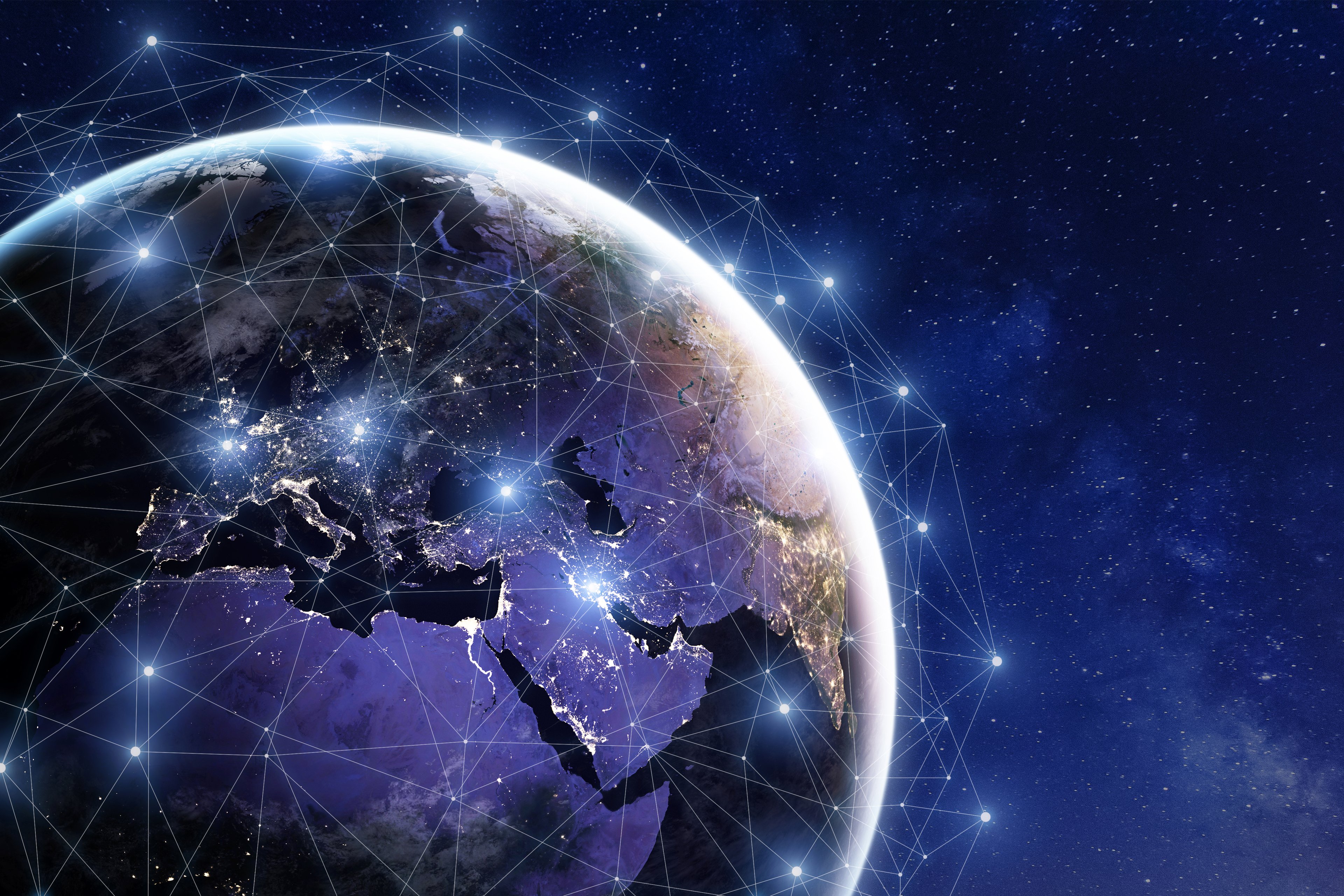 Earth at night, with lit web connecting cities.