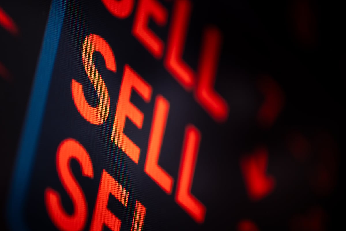An illuminated sign reading "Sell sell sell" in red letters.