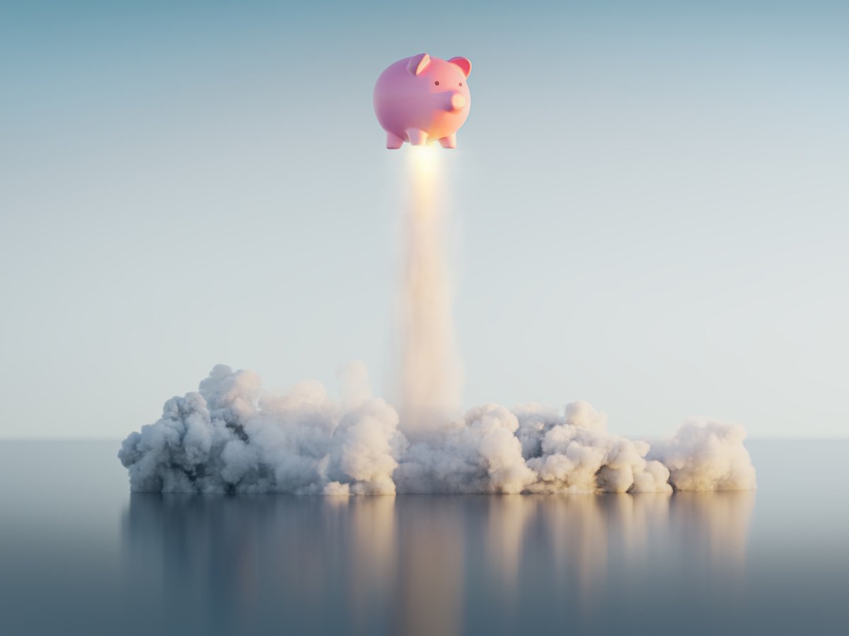 A piggy bank shooting up into the sky.