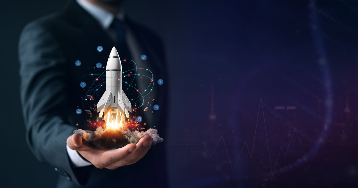 A person holding a rocket in their hand. 